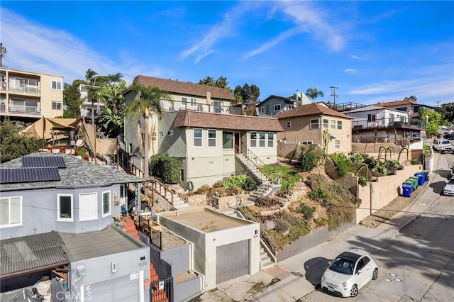 view of front of property featuring stairway, a vegetable garden, and a residential view