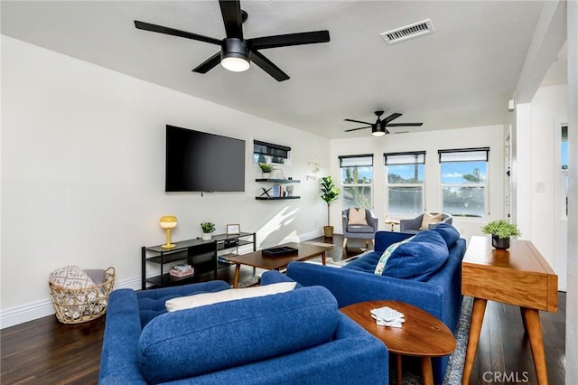 living area featuring a ceiling fan, baseboards, visible vents, and wood finished floors