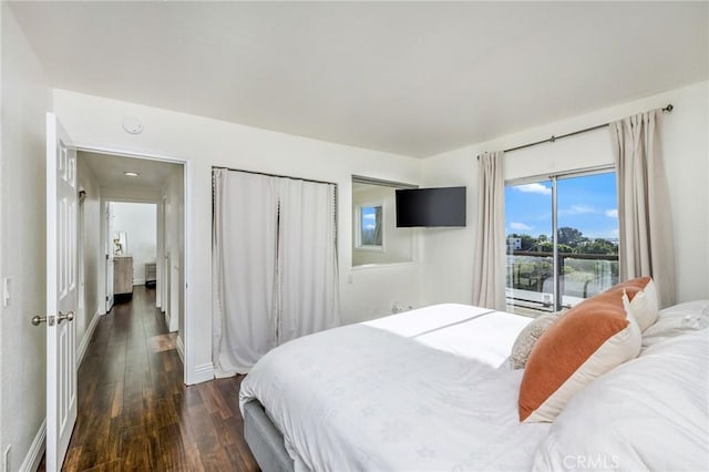 bedroom featuring dark wood-style flooring and baseboards