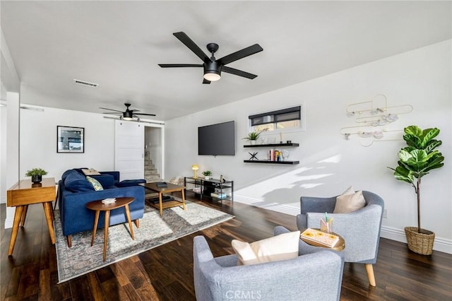 living area with stairway, baseboards, visible vents, and wood finished floors