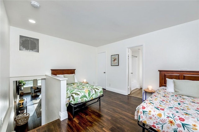 bedroom with baseboards and wood finished floors