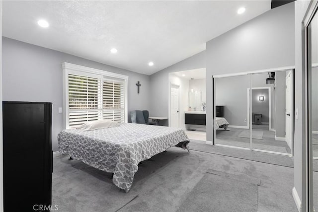 carpeted bedroom featuring ensuite bath, baseboards, vaulted ceiling, and recessed lighting