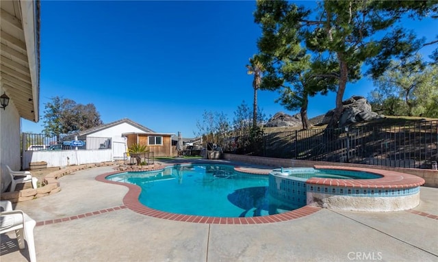 view of swimming pool featuring a patio, fence, and a pool with connected hot tub