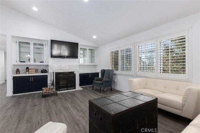 living area with a fireplace, recessed lighting, vaulted ceiling, wood finished floors, and baseboards