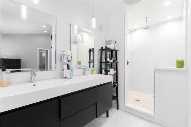 bathroom featuring double vanity, walk in shower, a sink, and recessed lighting