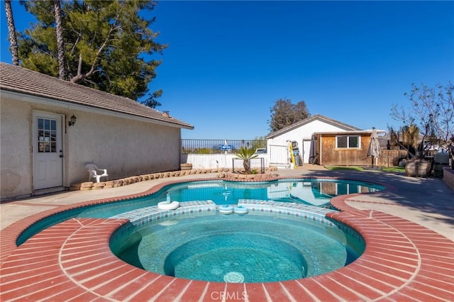 view of swimming pool with a patio area, fence, and a pool with connected hot tub