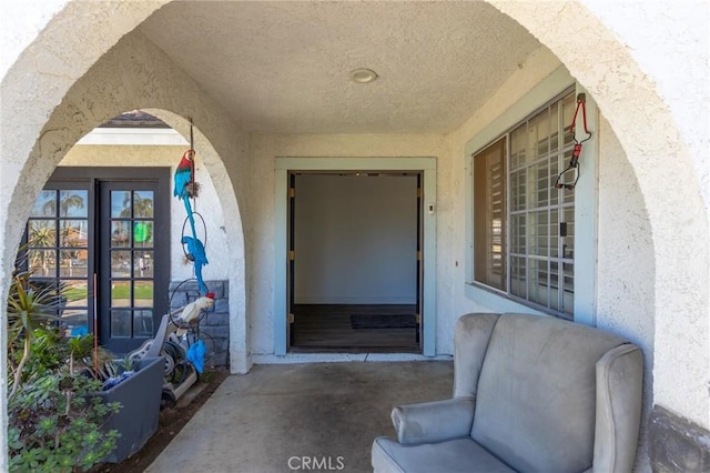 doorway to property featuring stucco siding