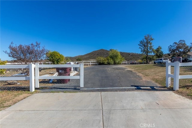 view of street with driveway and a mountain view