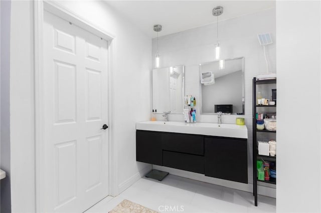 bathroom with double vanity, tile patterned flooring, and a sink