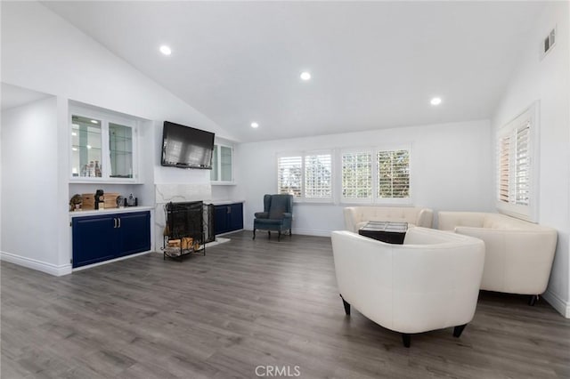 living area with dark wood-style floors, recessed lighting, visible vents, high vaulted ceiling, and baseboards