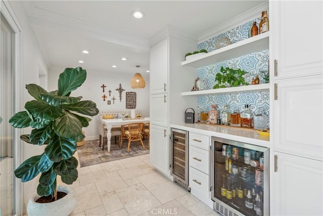 bar with a dry bar, beverage cooler, crown molding, and recessed lighting