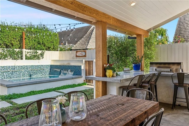 view of patio featuring fence private yard, outdoor dry bar, and outdoor dining space