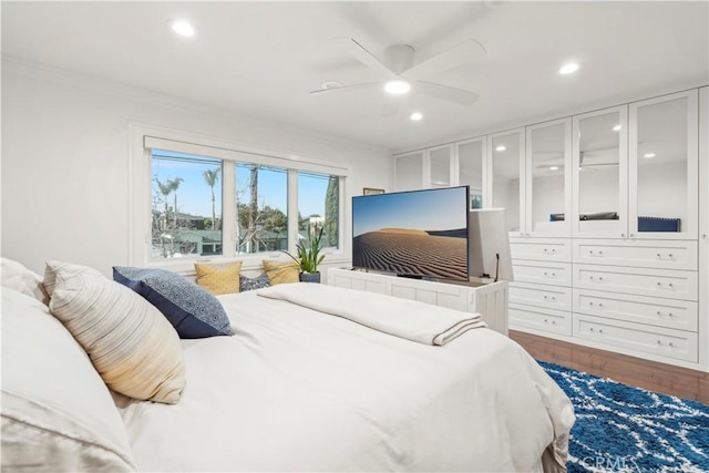 bedroom with ornamental molding, wood finished floors, and recessed lighting