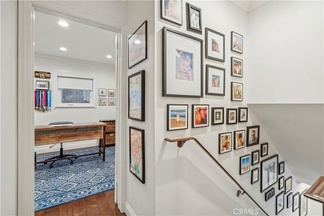 interior space with recessed lighting, dark wood finished floors, crown molding, and an upstairs landing