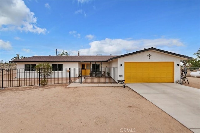 58676 Sunflower Dr, Yucca Valley, CA 92284 - ranch-style home with stucco siding, an attached garage, and concrete driveway