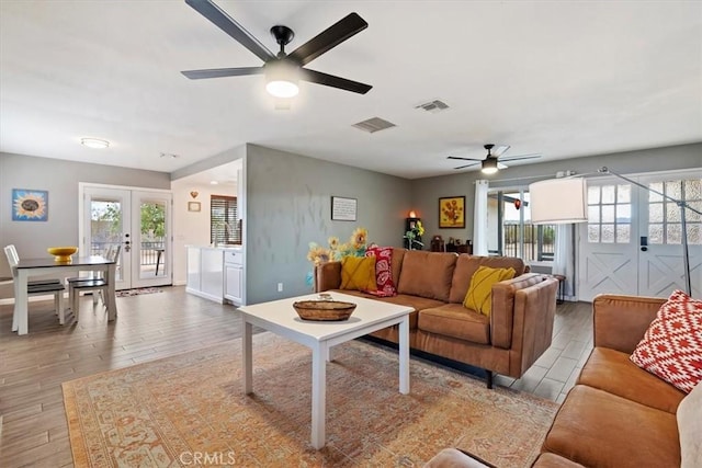 58676 Sunflower Dr, Yucca Valley, CA 92284 - living room featuring a ceiling fan, french doors, wood finished floors, and healthy amount of natural light