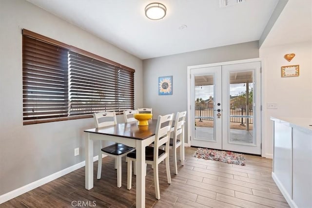 58676 Sunflower Dr, Yucca Valley, CA 92284 - dining room with french doors, wood finished floors, and baseboards