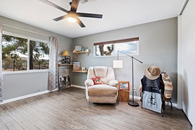 58676 Sunflower Dr, Yucca Valley, CA 92284 - living area featuring healthy amount of natural light, wood finished floors, and a ceiling fan