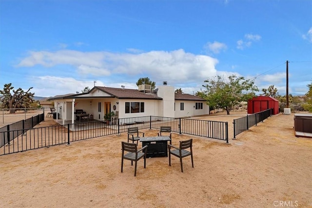 58676 Sunflower Dr, Yucca Valley, CA 92284 - back of property featuring a patio and an outdoor fire pit