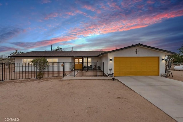 58676 Sunflower Dr, Yucca Valley, CA 92284 - ranch-style home with stucco siding, an attached garage, and driveway