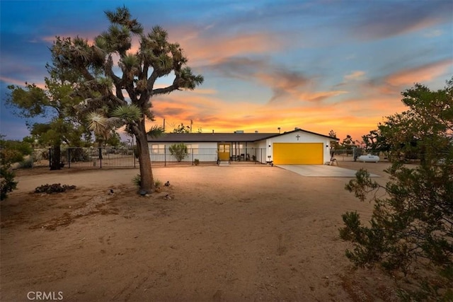 58676 Sunflower Dr, Yucca Valley, CA 92284 - view of front of house with an attached garage and dirt driveway