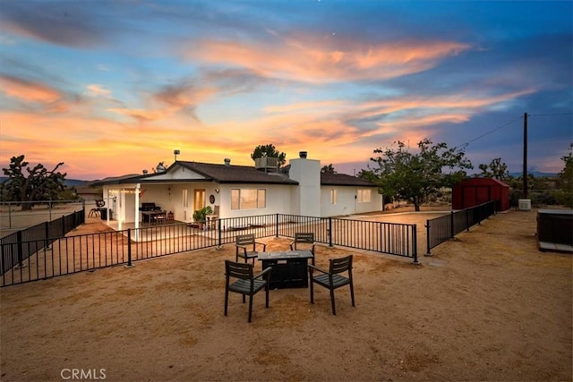 58676 Sunflower Dr, Yucca Valley, CA 92284 - back of house featuring a fenced backyard, a patio, an outdoor fire pit, and a chimney