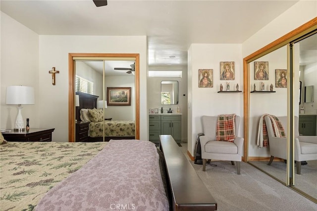 bedroom with a closet, connected bathroom, and carpet flooring