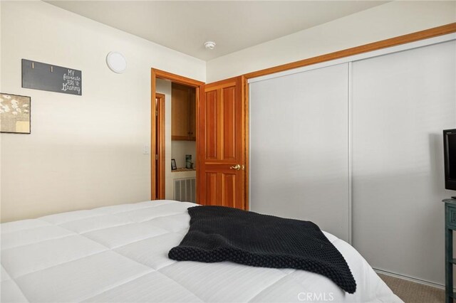 bedroom with visible vents and a closet