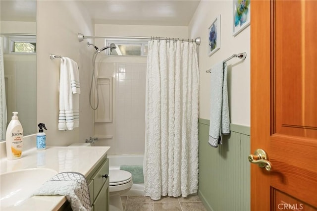 bathroom featuring shower / bath combo, vanity, toilet, and tile patterned floors