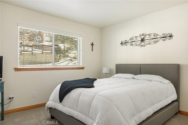 carpeted bedroom featuring baseboards