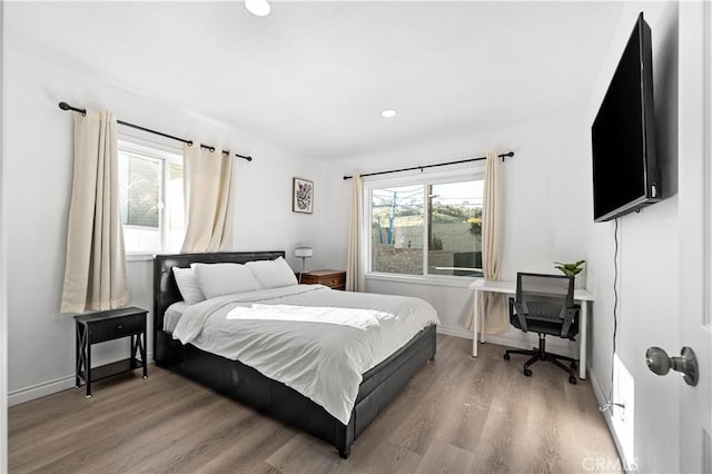 bedroom featuring recessed lighting, light wood-style flooring, and baseboards