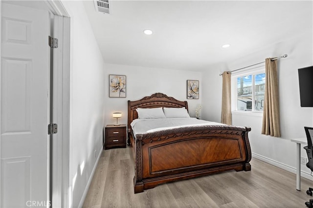 bedroom featuring light wood-style floors, baseboards, and visible vents