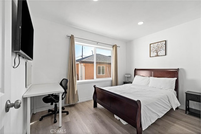 bedroom featuring recessed lighting, wood finished floors, and baseboards