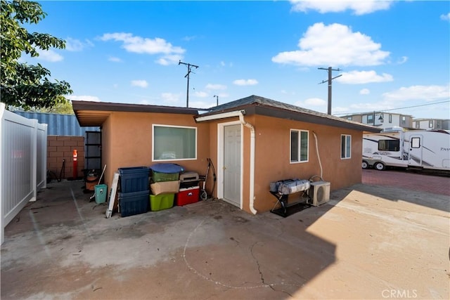 back of house with a patio area, fence, and stucco siding