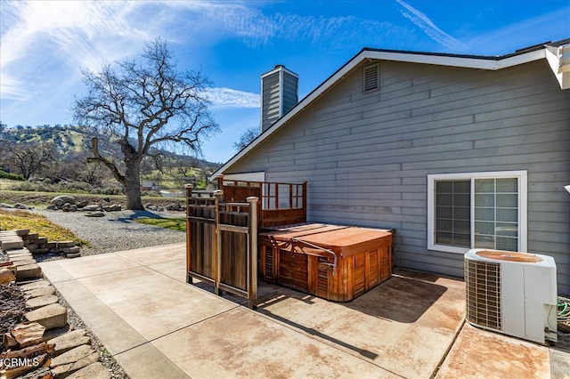 view of patio / terrace with central AC and a mountain view