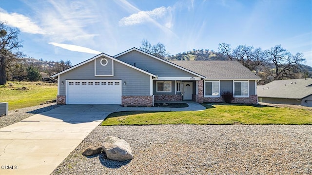 view of front of home with a garage, a front lawn, concrete driveway, and brick siding