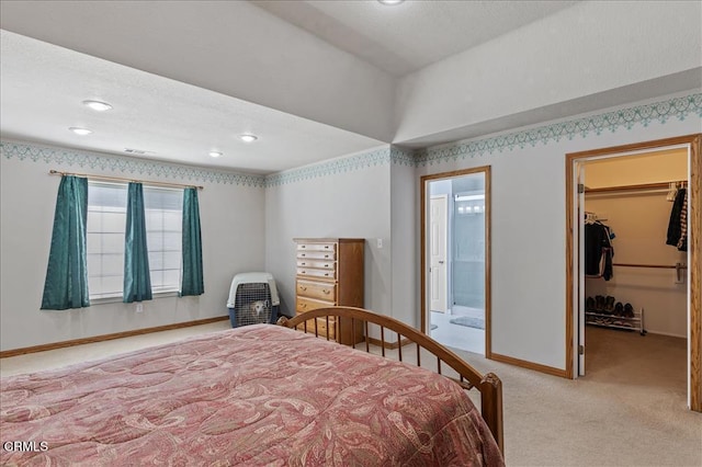 carpeted bedroom featuring a closet, visible vents, a spacious closet, and baseboards