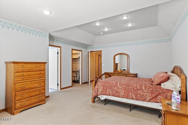 bedroom featuring a walk in closet, recessed lighting, a raised ceiling, and light colored carpet