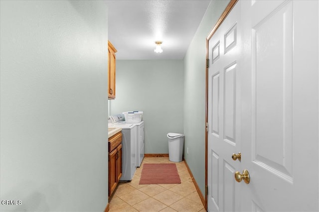 bathroom featuring washer and dryer, tile patterned flooring, vanity, and baseboards