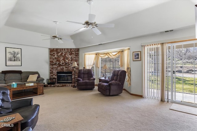 living area featuring carpet floors, lofted ceiling, visible vents, a brick fireplace, and ceiling fan