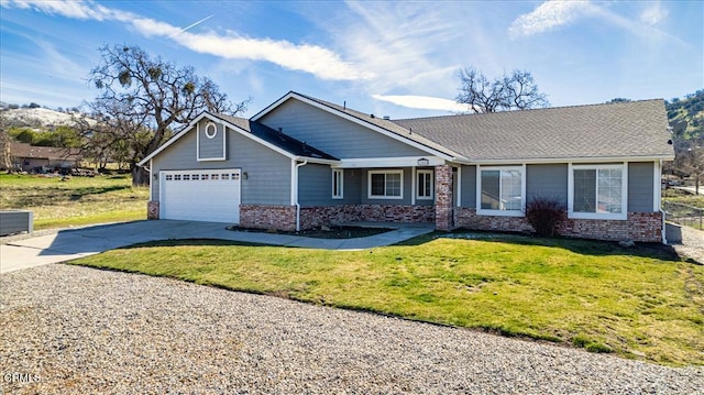 view of front of house featuring a garage, concrete driveway, brick siding, and a front lawn