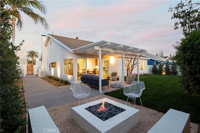 view of patio featuring a gate, a pergola, and an outdoor living space with a fire pit