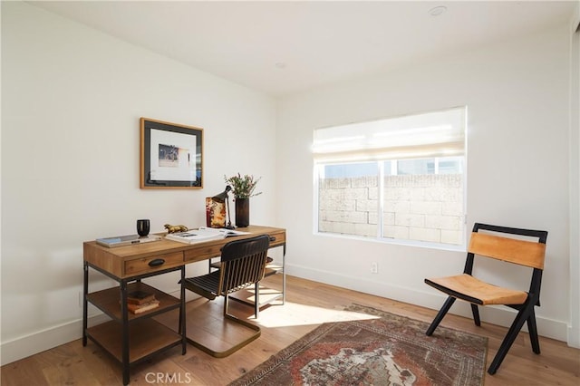 office featuring light wood-style flooring and baseboards