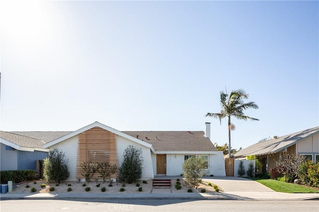 view of front of home featuring concrete driveway and stucco siding