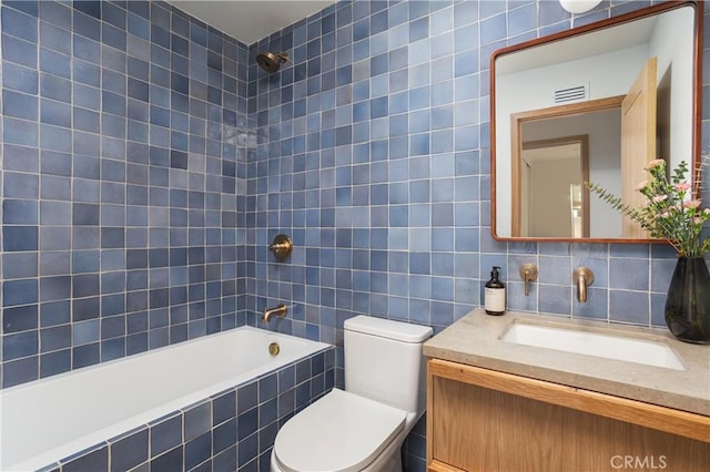 full bath featuring decorative backsplash, toilet, tiled shower / bath combo, vanity, and tile walls