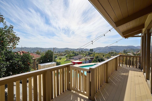 wooden deck featuring a mountain view and an outdoor structure