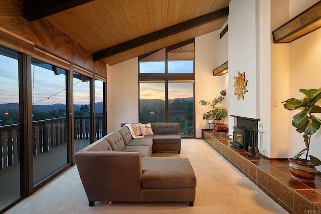 sunroom featuring a wood stove, wooden ceiling, and lofted ceiling with beams