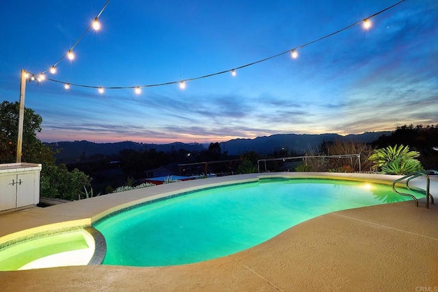 view of pool with a patio area and a pool with connected hot tub