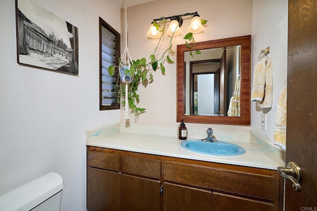 half bathroom with vanity and toilet