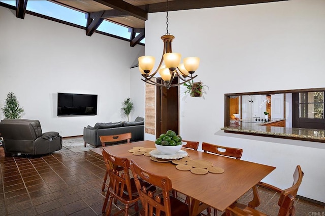 dining area featuring baseboards, high vaulted ceiling, beamed ceiling, and an inviting chandelier